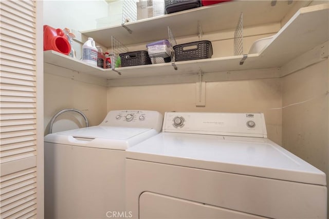 washroom with independent washer and dryer