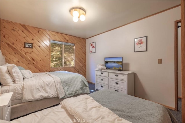 bedroom with carpet floors, crown molding, and wooden walls