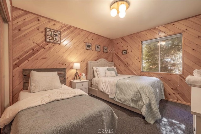 bedroom with carpet floors and wooden walls