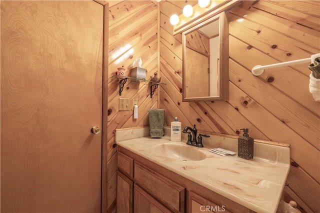 bathroom with wood walls and vanity