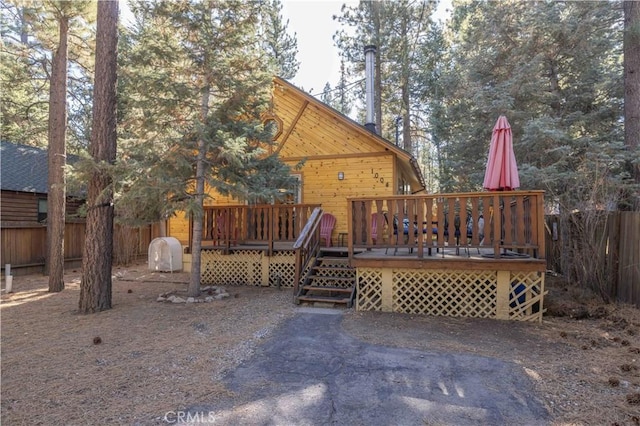 rear view of property with a wooden deck