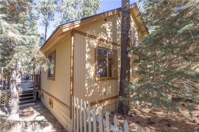 view of property exterior with a wooden deck