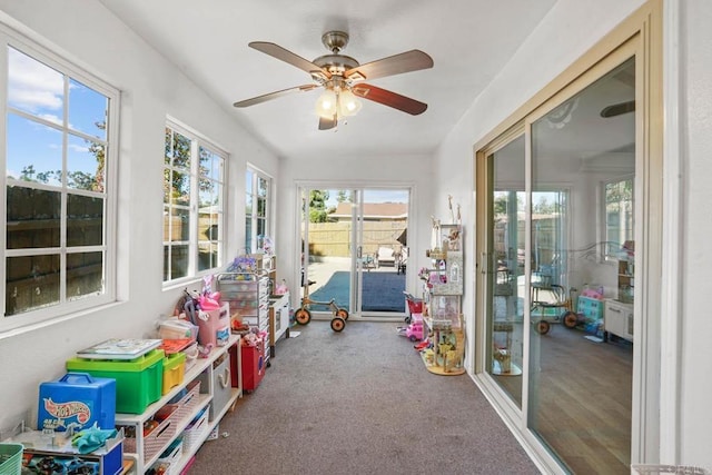 sunroom / solarium featuring ceiling fan