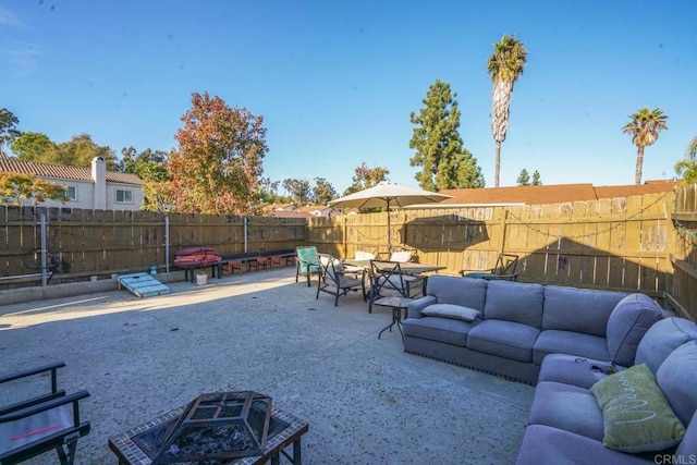 view of patio / terrace with an outdoor living space with a fire pit