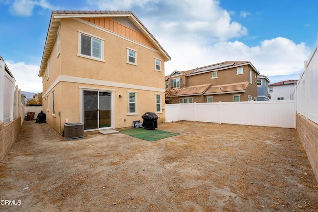 back of property with a patio area and central AC