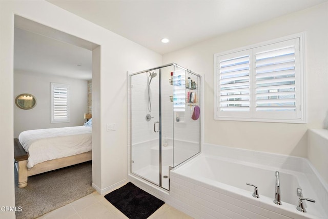 bathroom with shower with separate bathtub and tile patterned floors