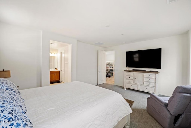 carpeted bedroom with ensuite bathroom