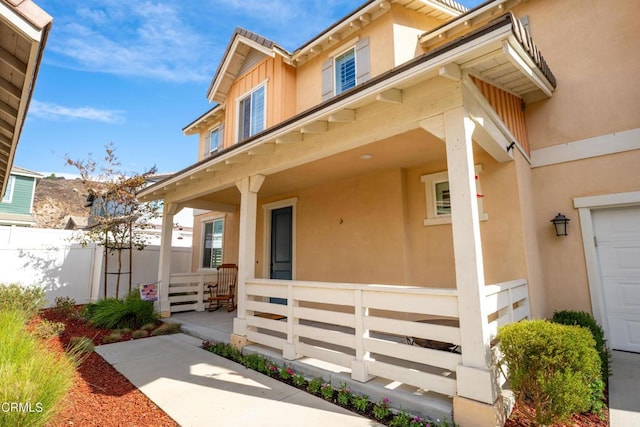 view of exterior entry featuring a porch