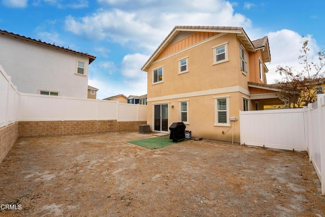 back of property with central air condition unit and a patio area