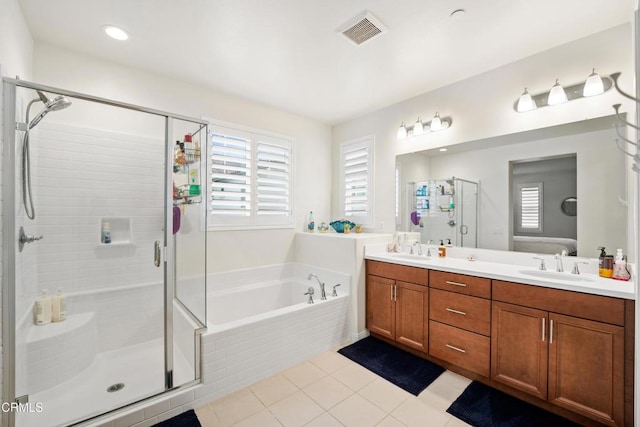 bathroom featuring shower with separate bathtub, vanity, and tile patterned floors