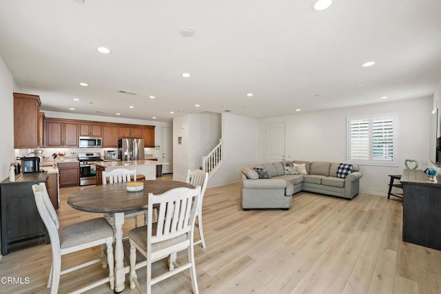 dining space with light hardwood / wood-style floors