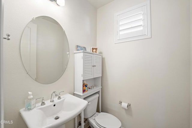 bathroom with toilet and sink