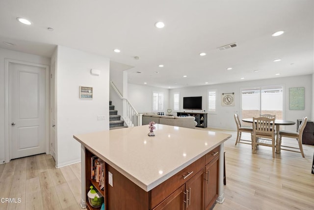 kitchen with a center island, light hardwood / wood-style flooring, and a healthy amount of sunlight