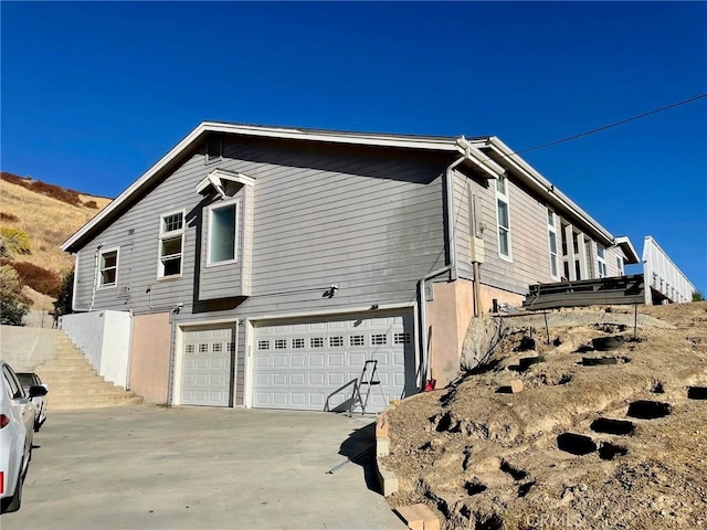 view of side of property with a garage