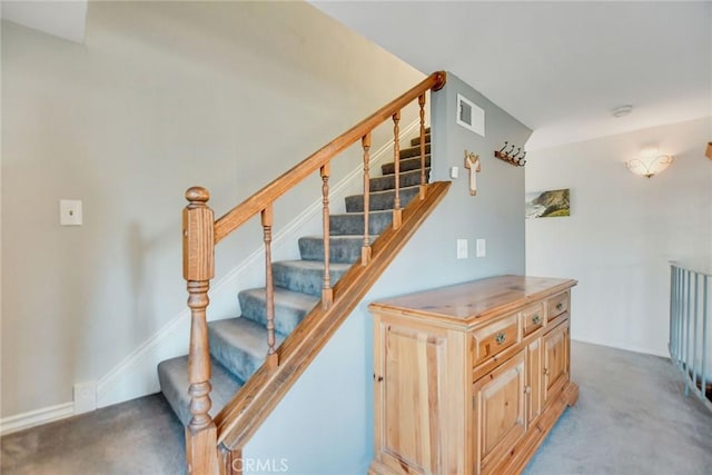 staircase featuring carpet floors