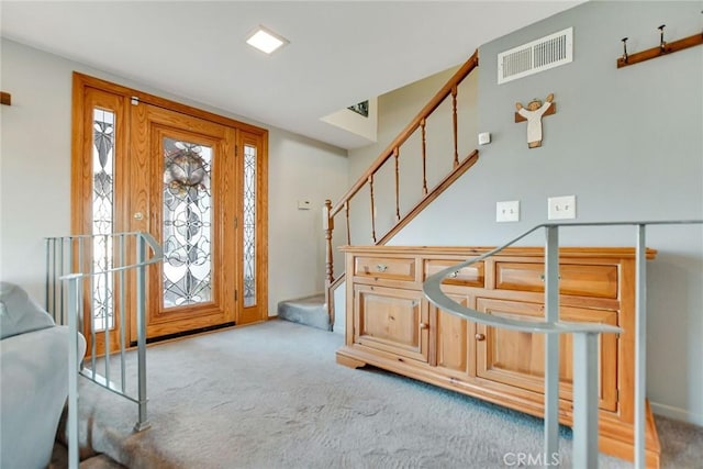 view of carpeted foyer entrance