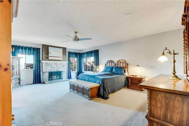 bedroom with multiple windows, ceiling fan, and light colored carpet