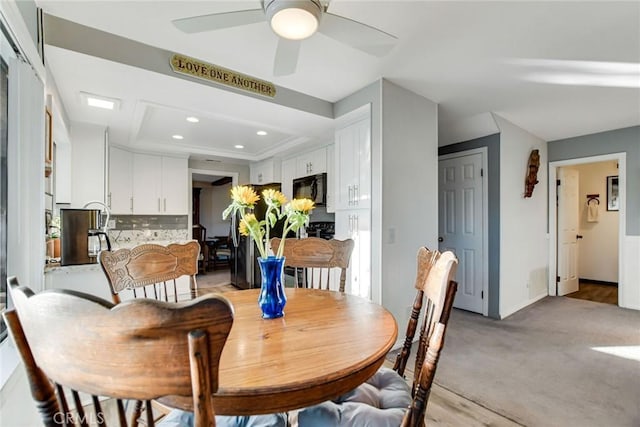 dining room featuring a tray ceiling and ceiling fan