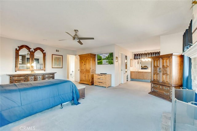 carpeted bedroom featuring ceiling fan and ensuite bathroom