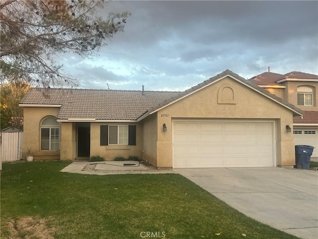 view of front of property with a garage and a front lawn