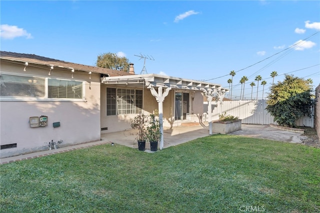 rear view of house featuring a lawn, a patio area, and a pergola