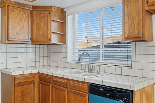 kitchen with tasteful backsplash, dishwasher, tile counters, and sink