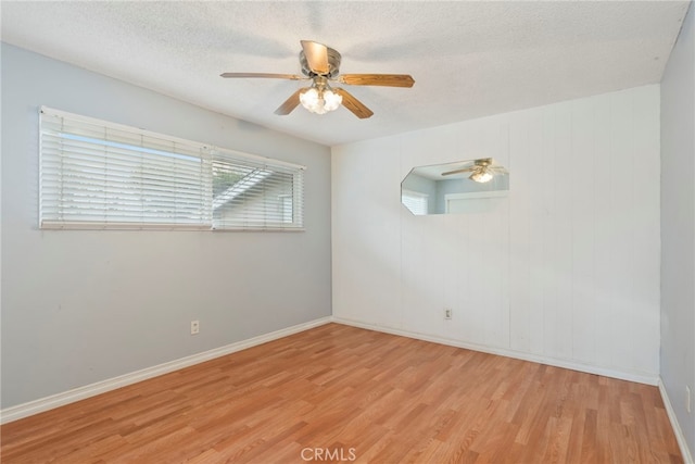 empty room featuring light hardwood / wood-style floors and a textured ceiling