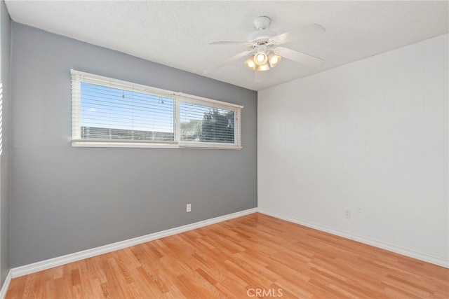 unfurnished room featuring hardwood / wood-style flooring, ceiling fan, and a textured ceiling