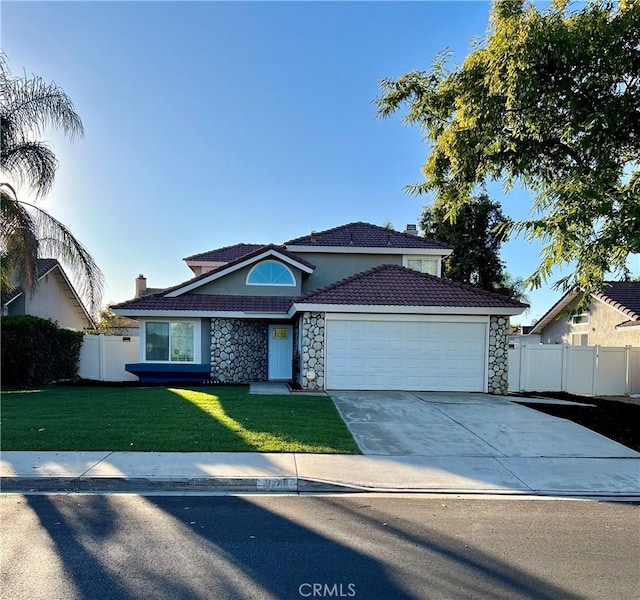 view of front of home with a garage and a front lawn