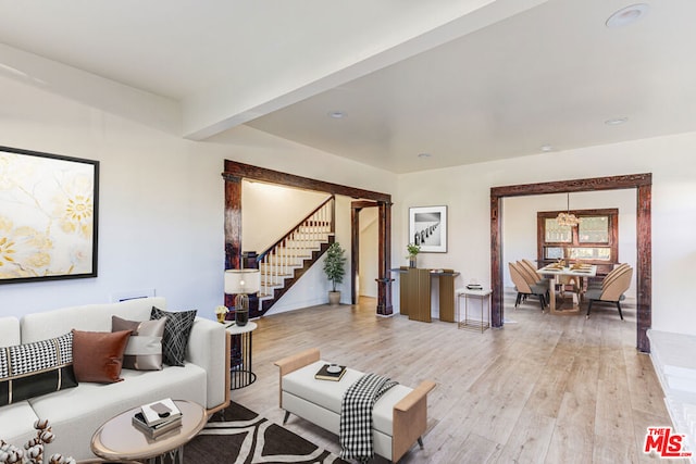 living room with beam ceiling and light hardwood / wood-style flooring