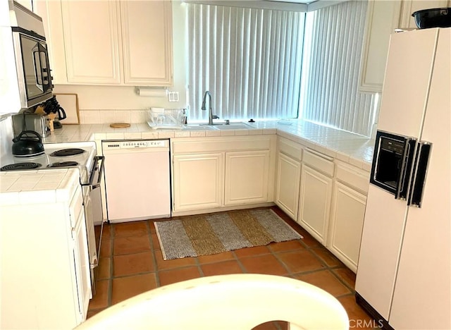 17 La Cerra Cir, Rancho Mirage, CA 92270 - kitchen featuring white appliances, a sink, tile countertops, and tile patterned flooring