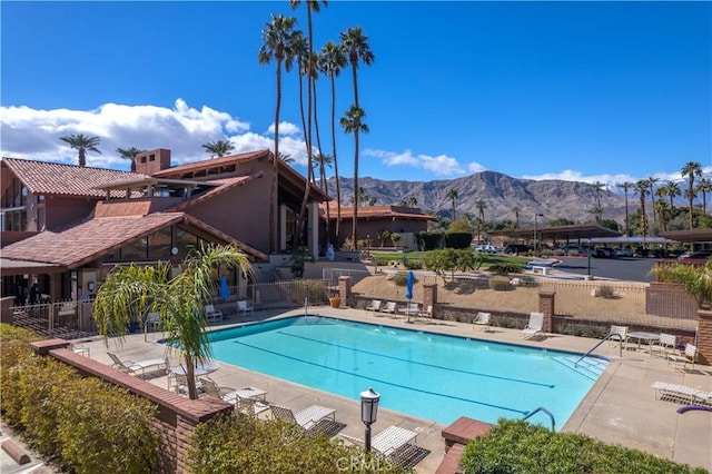 view of swimming pool with a patio area and a mountain view