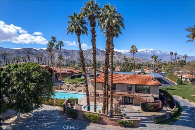 exterior space featuring a mountain view and a community pool