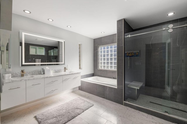 bathroom featuring tile patterned flooring, shower with separate bathtub, vanity, and a healthy amount of sunlight