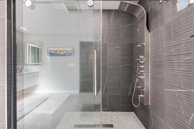 bathroom with tile patterned floors and a shower with door