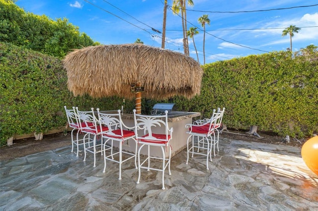 view of patio with a grill and exterior bar