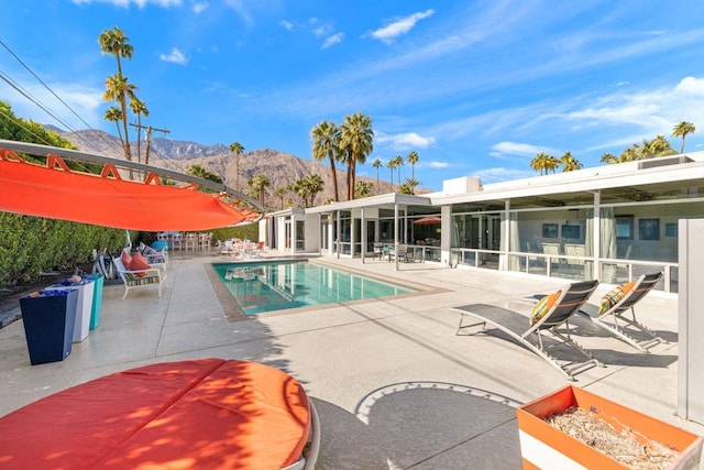 view of swimming pool featuring a mountain view and a patio