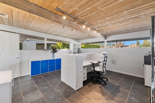 office space with beam ceiling, wooden ceiling, and rail lighting