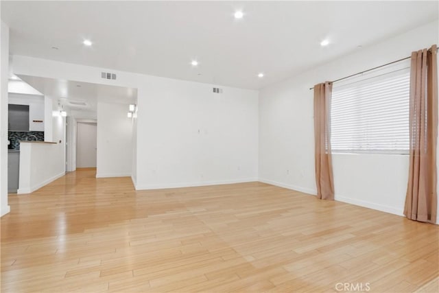 spare room featuring light hardwood / wood-style floors