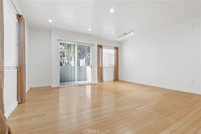 unfurnished room with light wood-type flooring