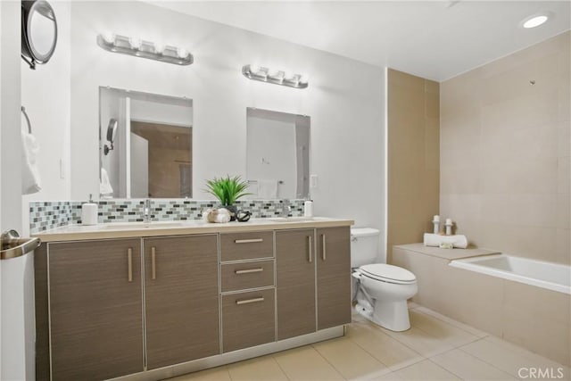 bathroom featuring toilet, vanity, backsplash, and tile patterned floors