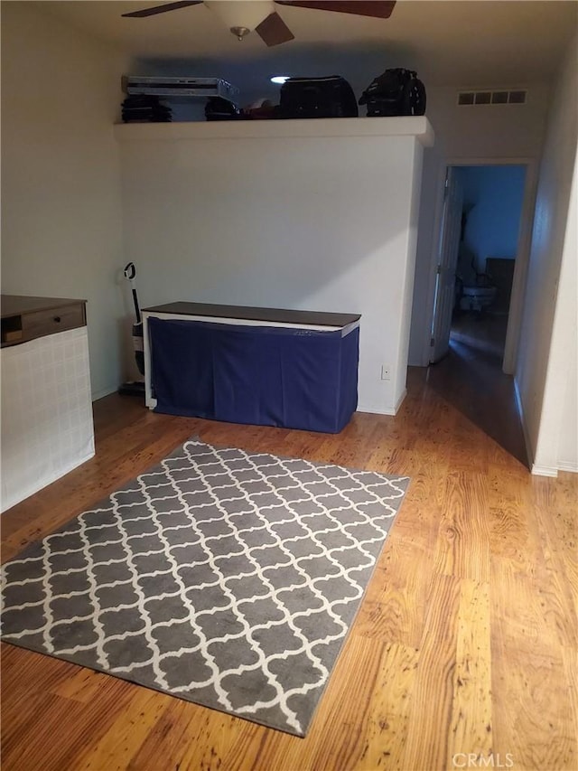 unfurnished bedroom featuring hardwood / wood-style flooring and ceiling fan