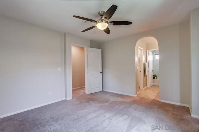 unfurnished bedroom with light colored carpet and ceiling fan