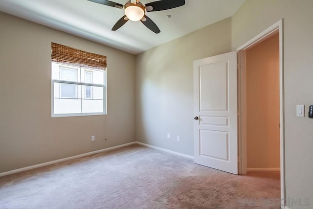 carpeted empty room featuring ceiling fan