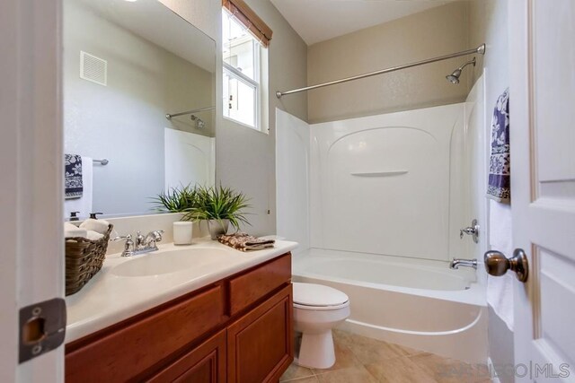 full bathroom with toilet, vanity, tile patterned floors, and shower / washtub combination