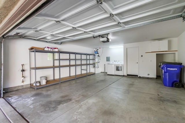 garage featuring washer and clothes dryer and a garage door opener