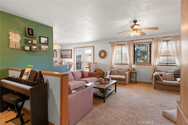 carpeted living room with ceiling fan, french doors, and a textured ceiling