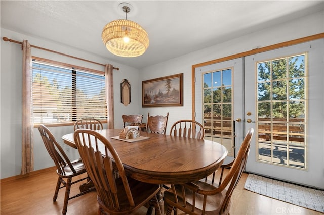 dining room with french doors and hardwood / wood-style flooring