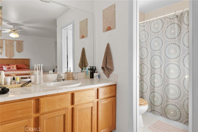 bathroom featuring tile patterned floors, ceiling fan, toilet, and vanity