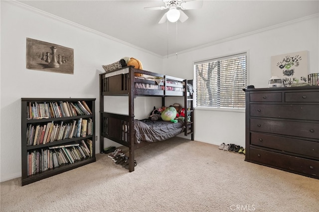 carpeted bedroom with ceiling fan and ornamental molding